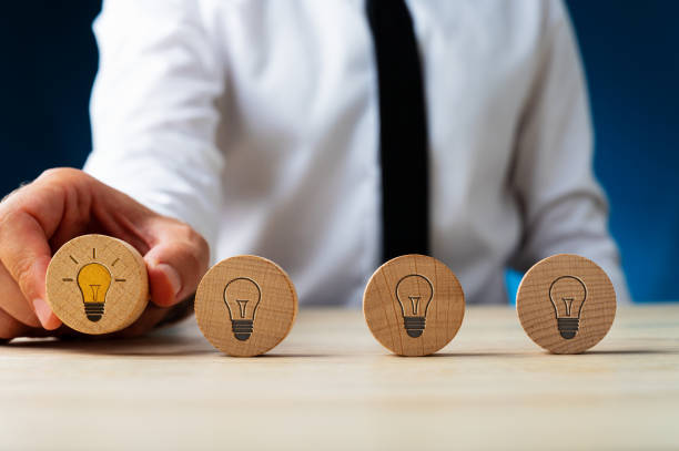 istock Four wooden circles with light bulb symbols on them 1173518244
