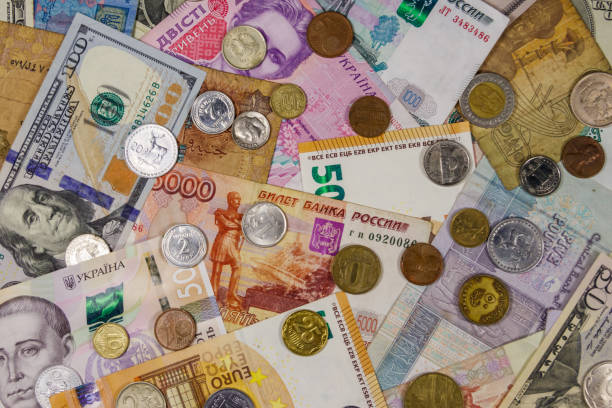 istock Background of banknotes and coins from different countries 1173520176