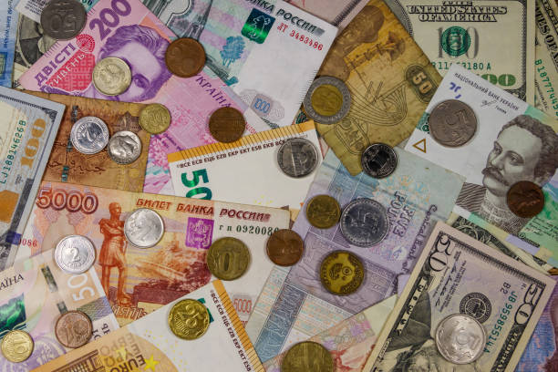istock Background of banknotes and coins from different countries 1173520188