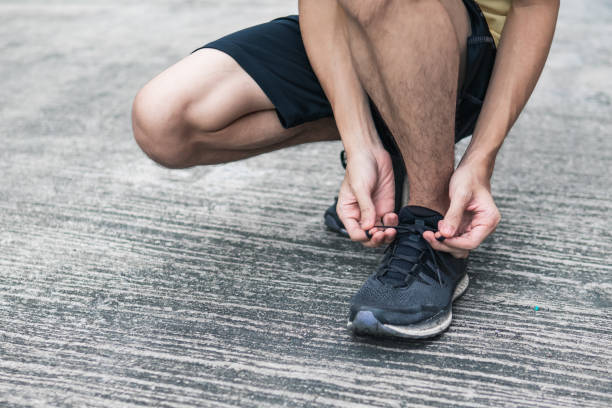 istock Runner tying running shoes laces 1173521471