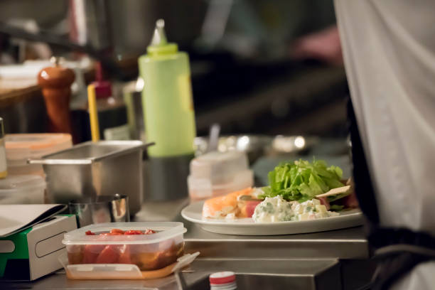 istock Chef serving food to plates 1173521610