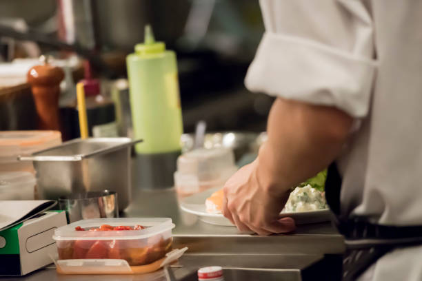 istock Chef serving food to plates 1173521674