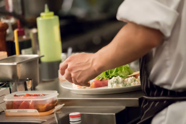 istock Chef serving food to plates 1173521722