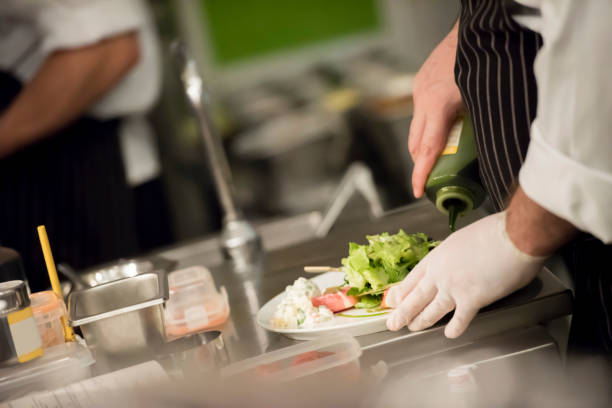 istock Chef putting dressing on the salad 1173522008