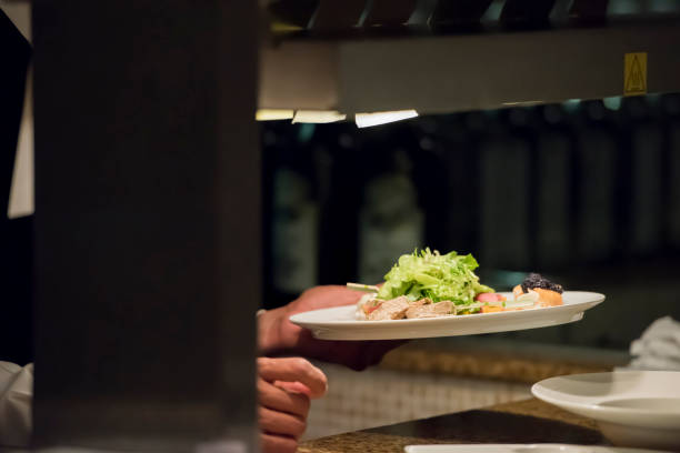 istock Chef is handing out plate to waiter 1173522229