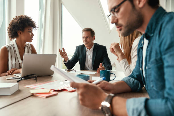 istock Business meeting. Multicultural team discussing new project while sitting at the office table 1173524061