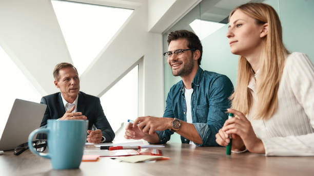 istock We have great results! Business team discussing something and smiling while sitting in the modern office 1173524553