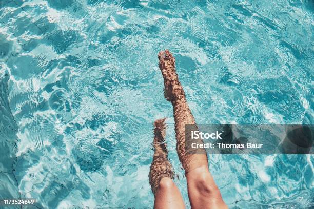 Beautiful Womans Legs In The Pool Stock Photo - Download Image Now - Swimming Pool, Summer, Women