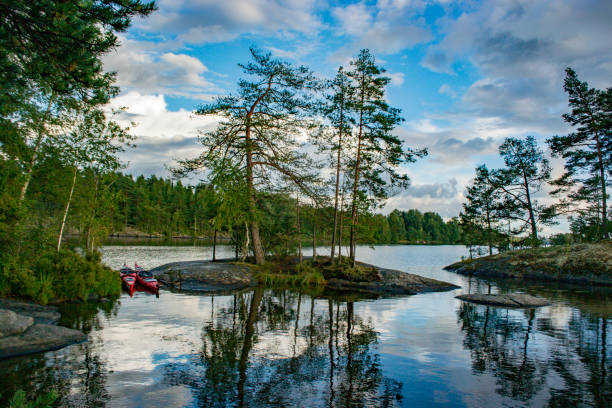 Photo of Lake with trees and rocks in the Dalsland Lake District in Sweden.