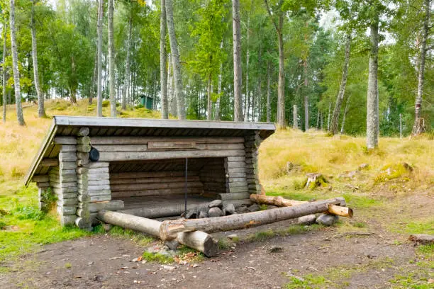 Shelter next to a lake surrounded by pine trees in the Dalsland Lake District in Sweden during summer