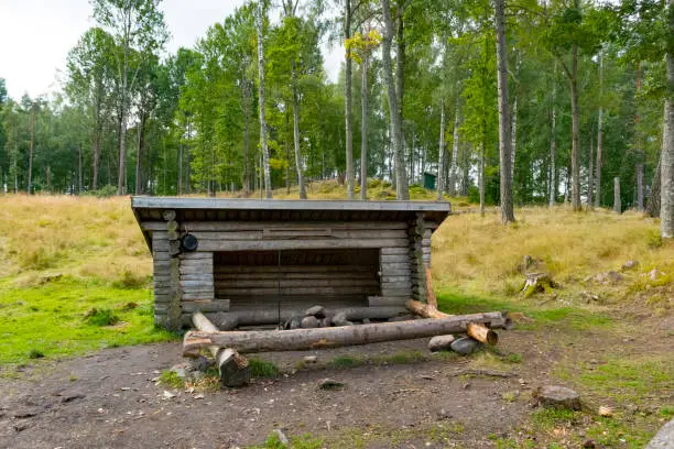 Shelter next to a lake surrounded by pine trees in the Dalsland Lake District in Sweden during summer