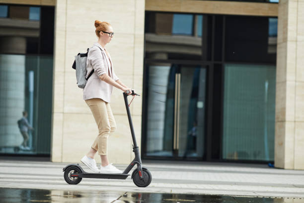 istock Young Woman Riding Electric Scooter Background 1173528099