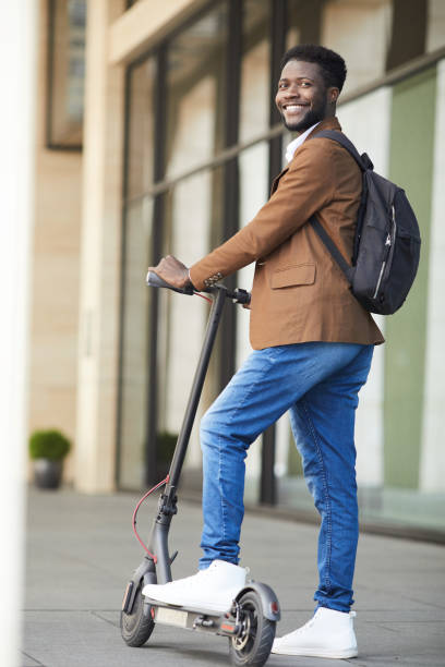 istock Modern African-American Man Posing with Scooter 1173528173