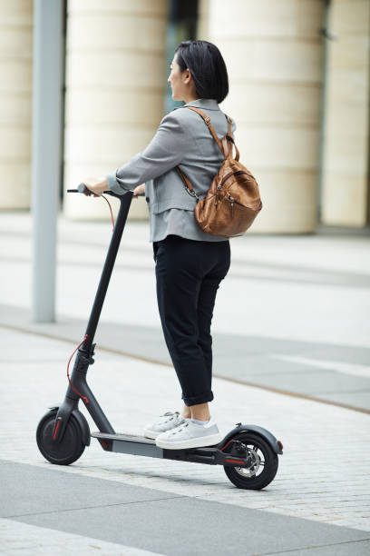 istock Asian Woman Riding Electric Scooter 1173529420
