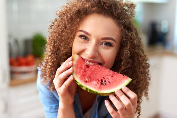 Beautiful woman eating a watermelon