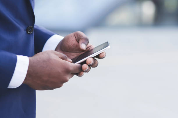 istock Afro Businessman Hands Using Smartphone In City, Closeup 1173530241