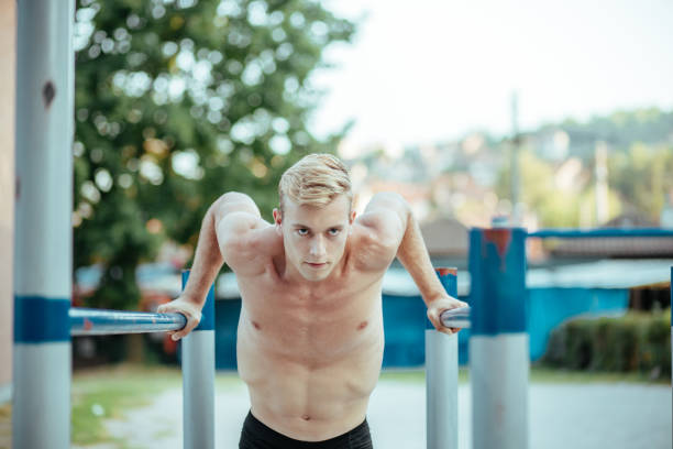 istock Young muscular man training strength outdoors 1173530798
