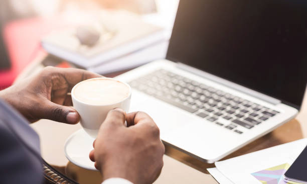 istock Unrecognizable Businessman Holding Coffee Cup Working At Laptop In Cafe 1173530871