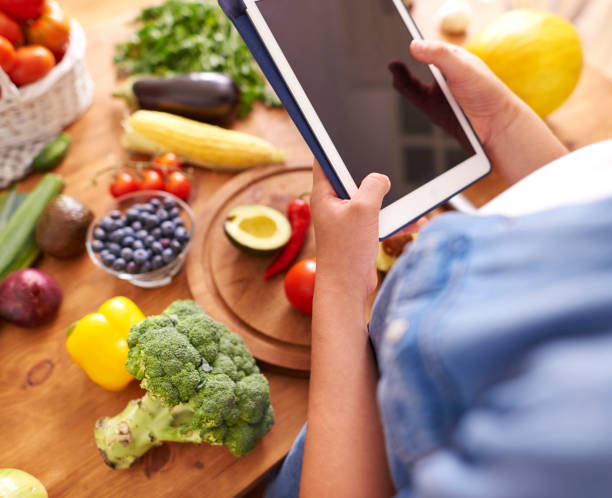istock Woman with digital tablet in the kitchen 1173531153