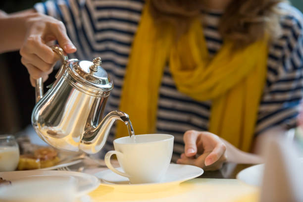 istock Woman pouring tea in cup 1173532508