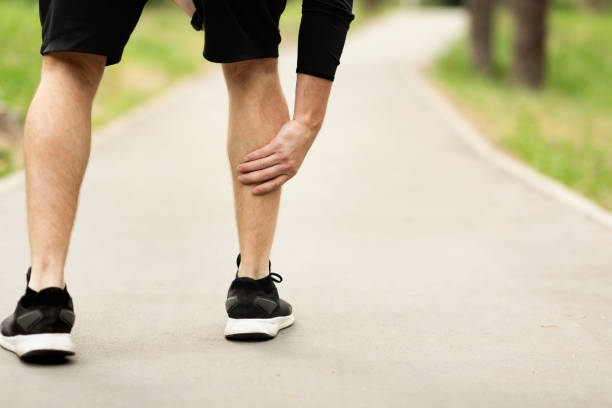 istock Male runner is suffering from calf pain on jogging 1173534679