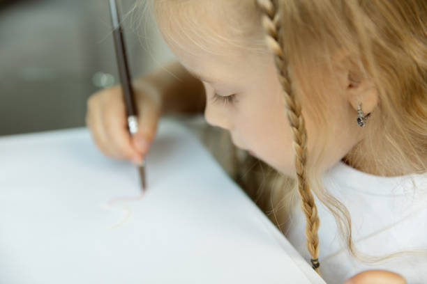 istock Little girl studying to write or draw. Homeschooling concept 1173535085