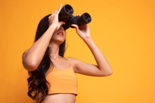 istock Young Asian woman with binoculars. 1173535377