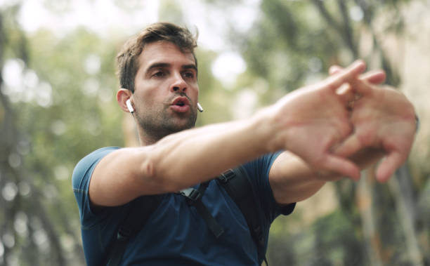 Cropped shot of a handsome middle aged man stretching before hiking