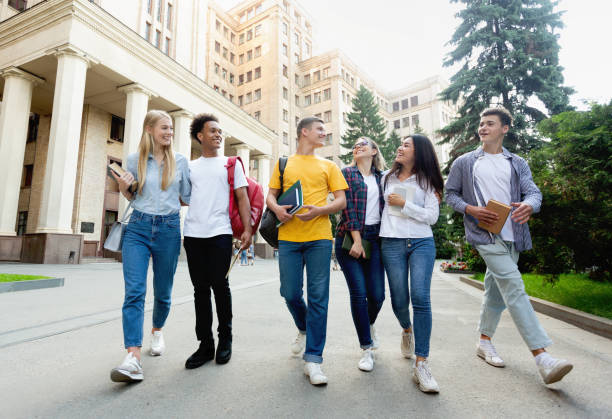 istock Free time of students. Friendly students walking after classes 1173541736