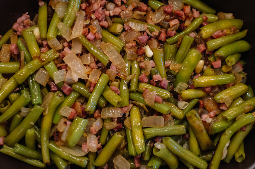Close up. Green beans and serrano ham. Spanish cuisine. Food an texture concept.