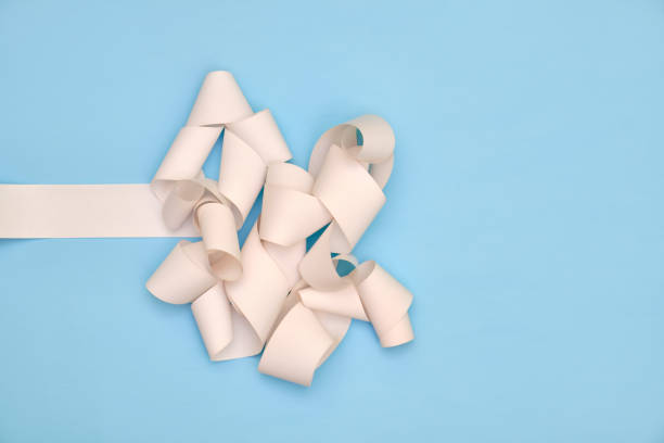 istock Twisted paper receipt on blue background 1173542261