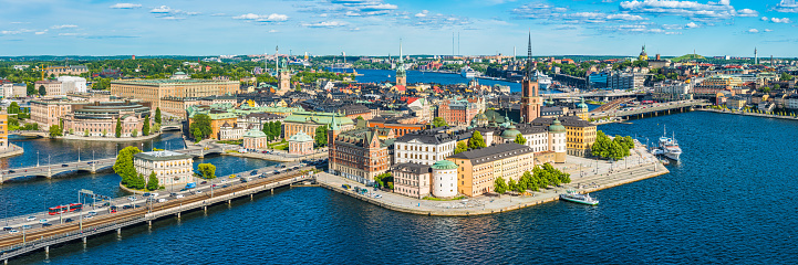 Panoramic aerial view over the blue summer skies above the iconic waterfront of Gamla Stan and Sodermalm in the heart of Stockholm, Sweden's vibrant capital city.