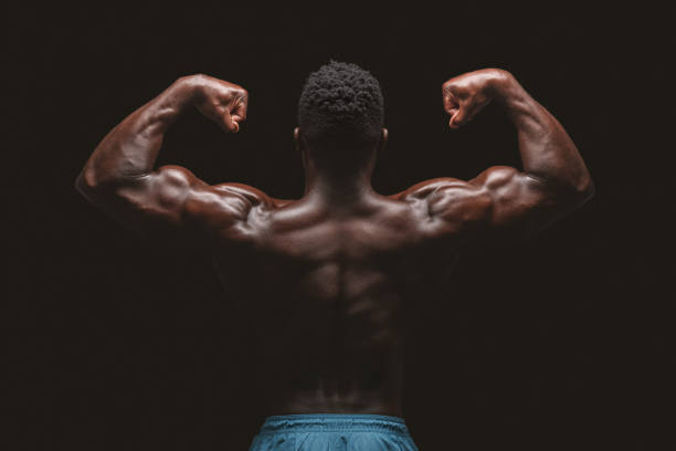istock Athletic african american male bodybuilder flexing muscles 1173546123