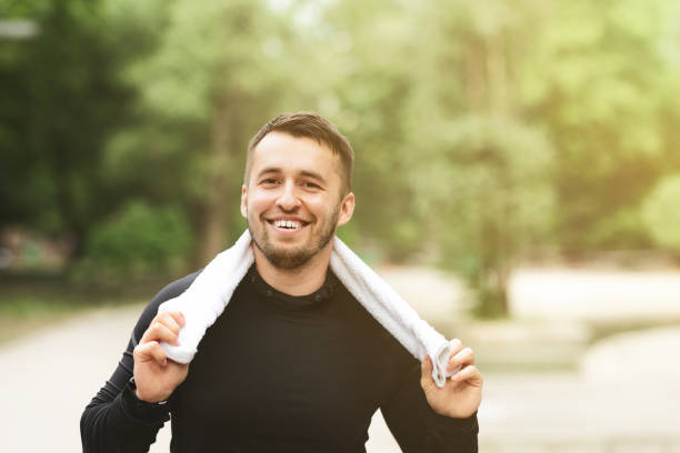 istock Cheerful man resting after workout with towel around his neck 1173546284