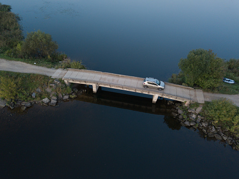 car passing over the bridge over the water