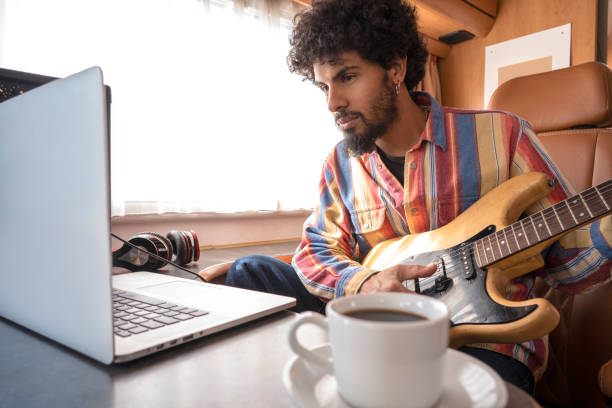 istock Digital Nomad young man guitar player in motorhome 1173548946