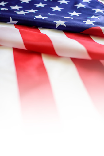 Image of closed up of American Flag with star and strips unfurled in the wind.