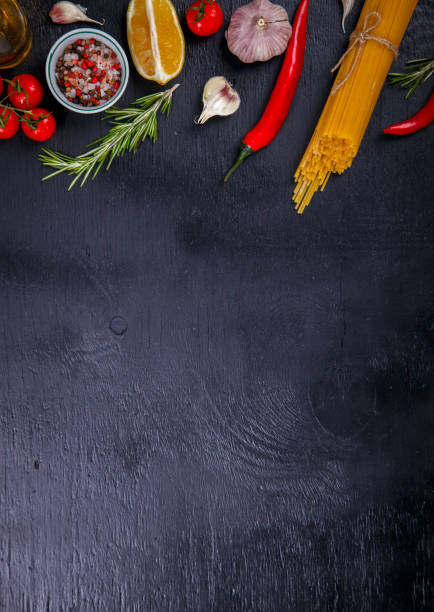 istock Pasta Spaghetti with Ingredients for cooking pasta on a on Black Background, top view. Copy space for Text. selective focus. 1173550975