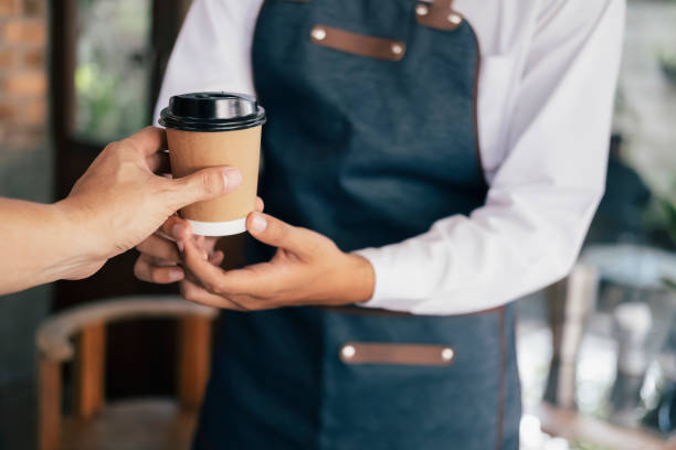 istock Young owner of coffee cafe service customer. 1173551597