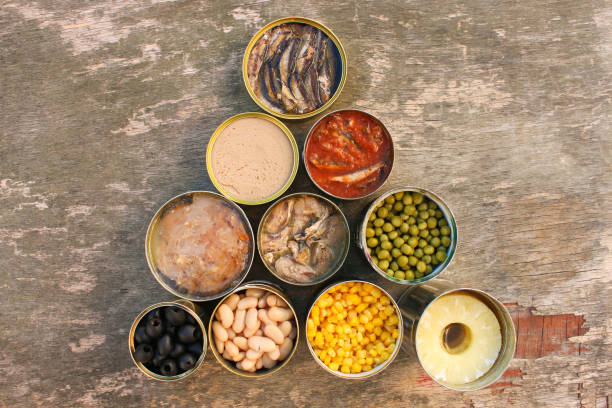 istock Different open canned food on old wooden background. Top view. Flat lay. 1173552436