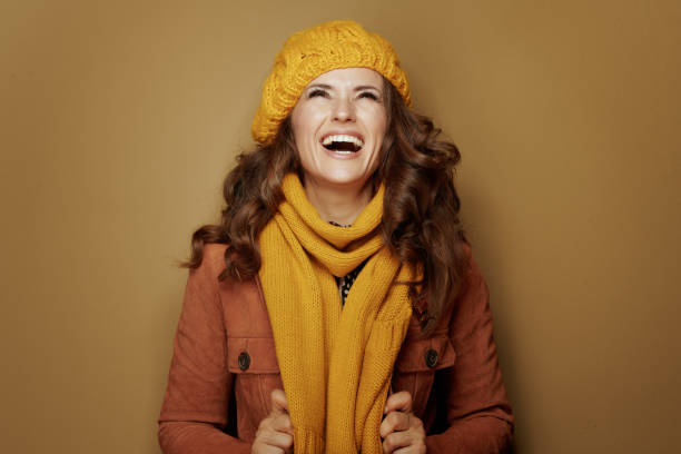 istock woman looking up on copy space isolated on beige background 1173552518