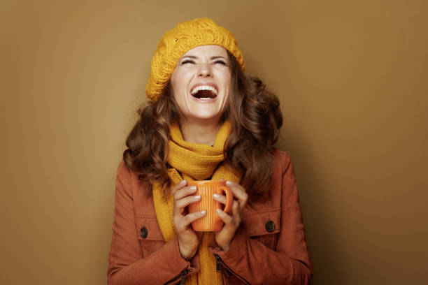 istock woman with cup of hot chocolate looking up at copy space 1173552521