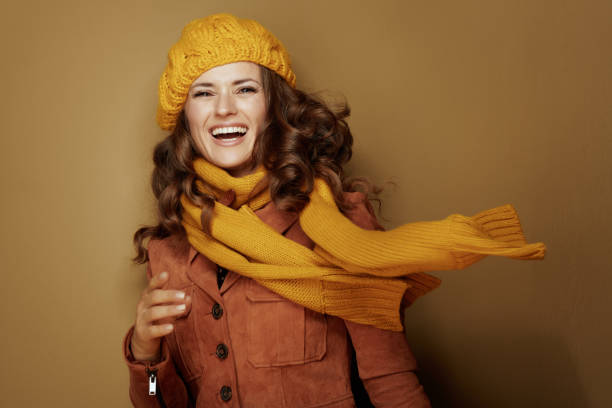 istock smiling trendy woman on bronze background 1173552527