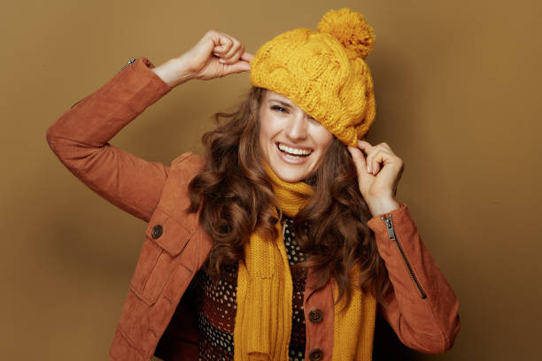 istock smiling woman playing with beret against brown background 1173553776