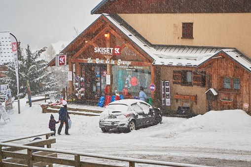 Les Sybelles, France - March 14, 2019: Skiset rental shop in Saint-Jean-d Arves village, Les Sybelles ski domain, during a snowy day, late Spring.