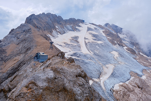 Marmolada glacier in the Italian Dolomites and Rifugio Serauta as seen from the via ferrata route called Eterna (Brigata di Cadore), in Summer.
