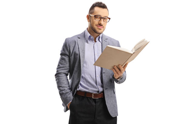 istock Young elegant man standing and holding an open book 1173556268