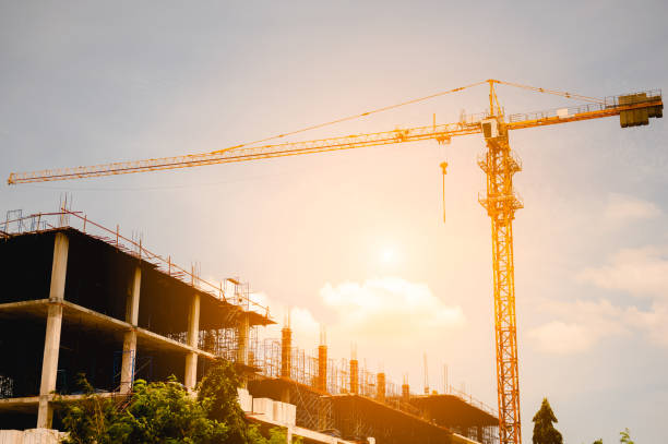 Building crane and buildings under construction in the city. stock photo