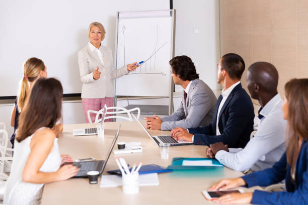 istock Woman making presentation on staff meeting 1173557391