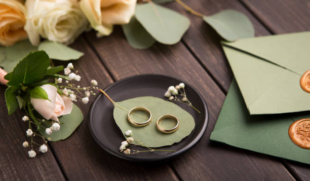 istock Creative Wedding rings composition on small plate on wood 1173557934